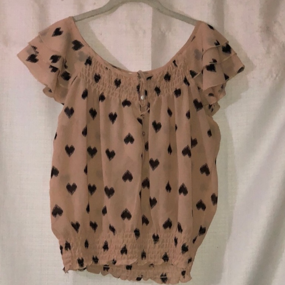 Pink blouse with black hearts on it
